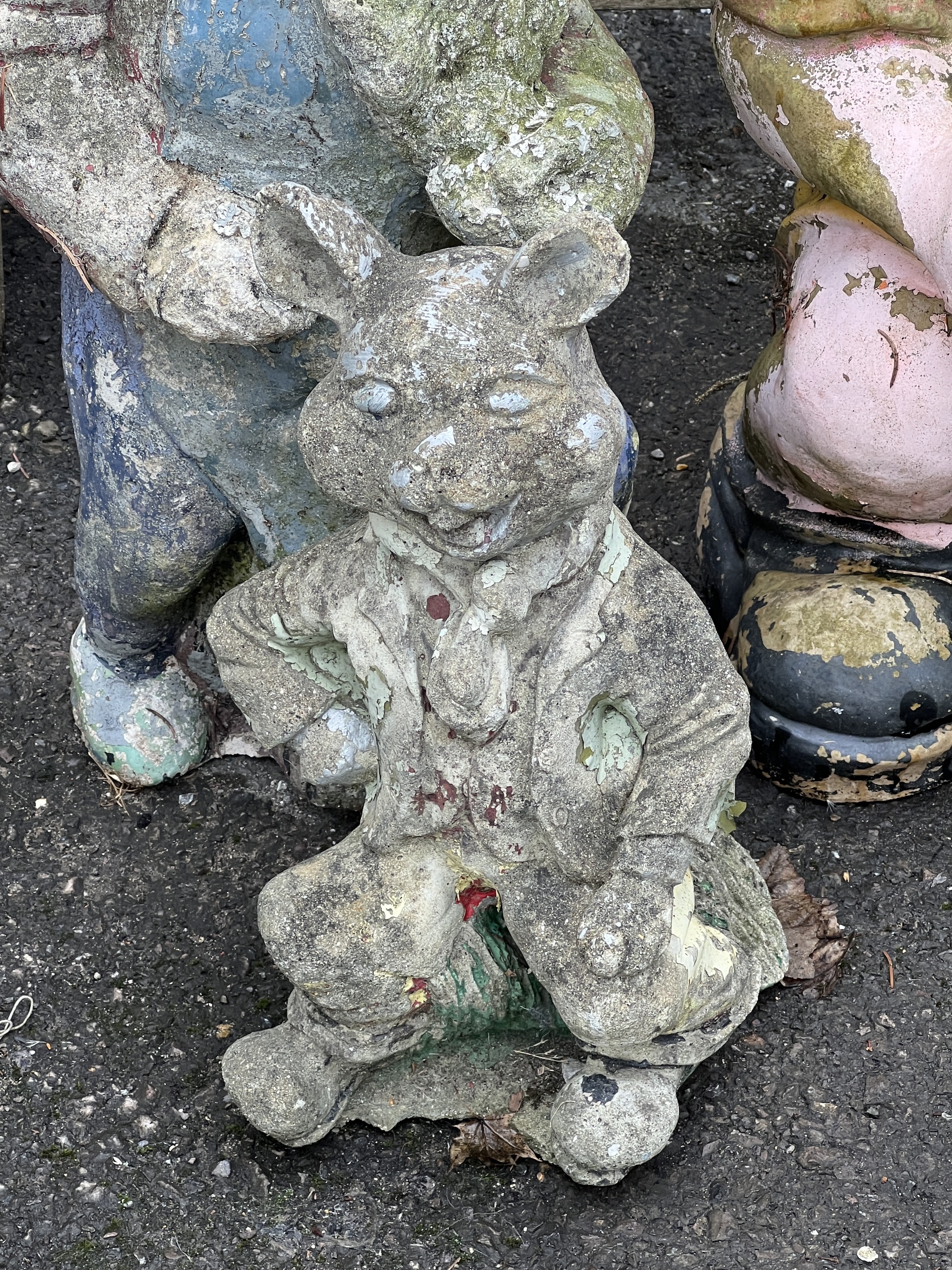 Two reconstituted stone and fibreglass gnome garden ornaments, larger height 65cm together with a seated pig garden ornament